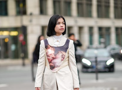 PARIS, FRANCE - JANUARY 27: A guest wears a white turtleneck pullover, a white shirt, a white latte ...