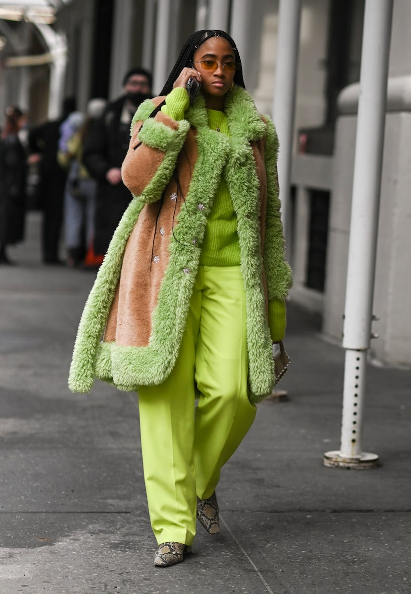NEW YORK, NEW YORK - FEBRUARY 16: Candace Marie is seen wearing a lime green faux fur coat, lime gre...