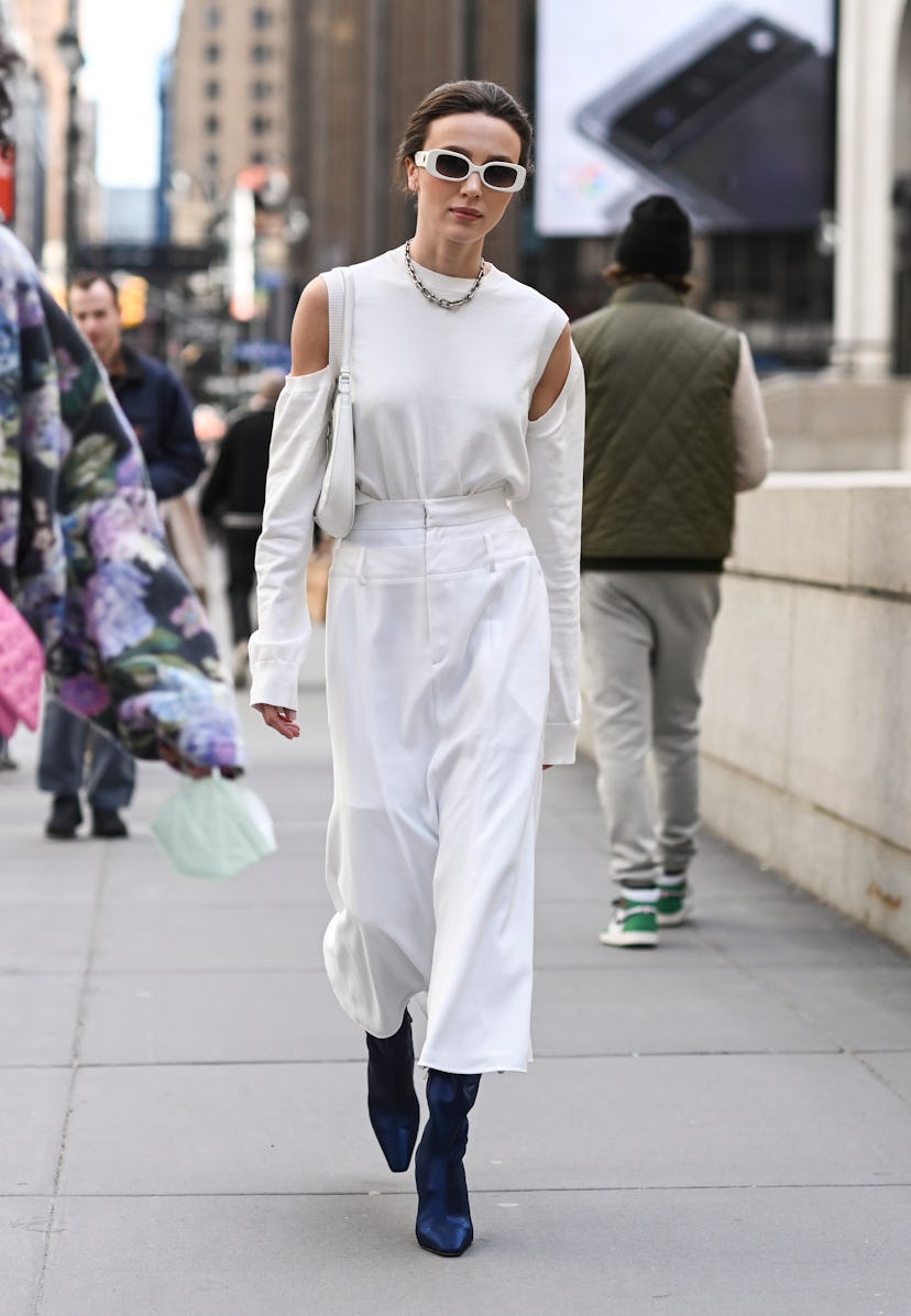 NEW YORK, NEW YORK - FEBRUARY 12:  Mary Leest is seen wearing a white outfit and blue boots outside ...