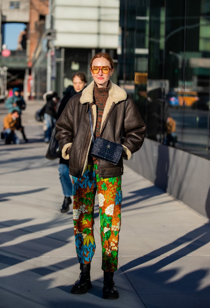 NEW YORK, NEW YORK - FEBRUARY 15: Hannah Baxter is seen wearing brown shearling jacket, black bag, p...