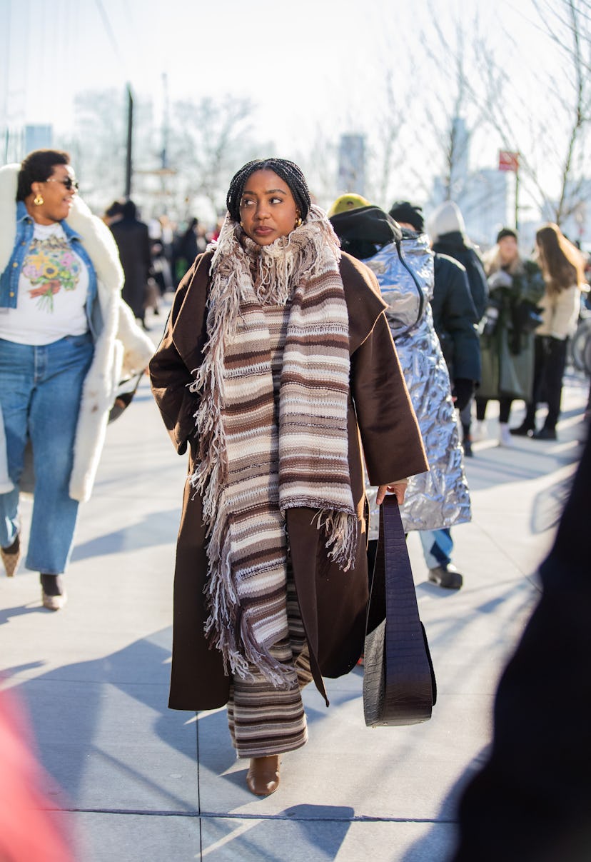 NEW YORK, NEW YORK - FEBRUARY 15: Lindsay Peoples Wagner seen wearing striped brown scarf, brown coa...