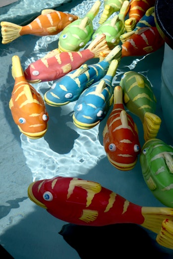 Carnival game with plastic fish swimming in the water.