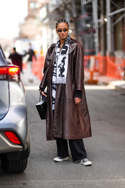NEW YORK, NEW YORK - FEBRUARY 12: A model wears black sunglasses, a black and white print pattern sc...