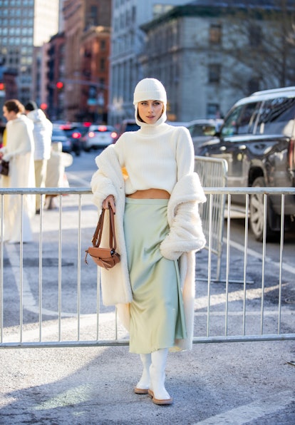 NEW YORK, NEW YORK - FEBRUARY 14: Sofia Eve wearing white turtleneck balaklava, silk skirt, brown ba...
