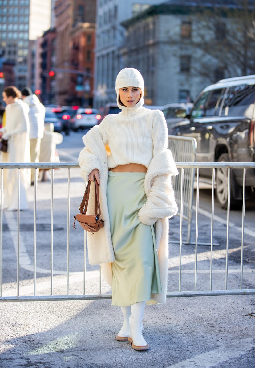 NEW YORK, NEW YORK - FEBRUARY 14: Sofia Eve wearing white turtleneck balaklava, silk skirt, brown ba...
