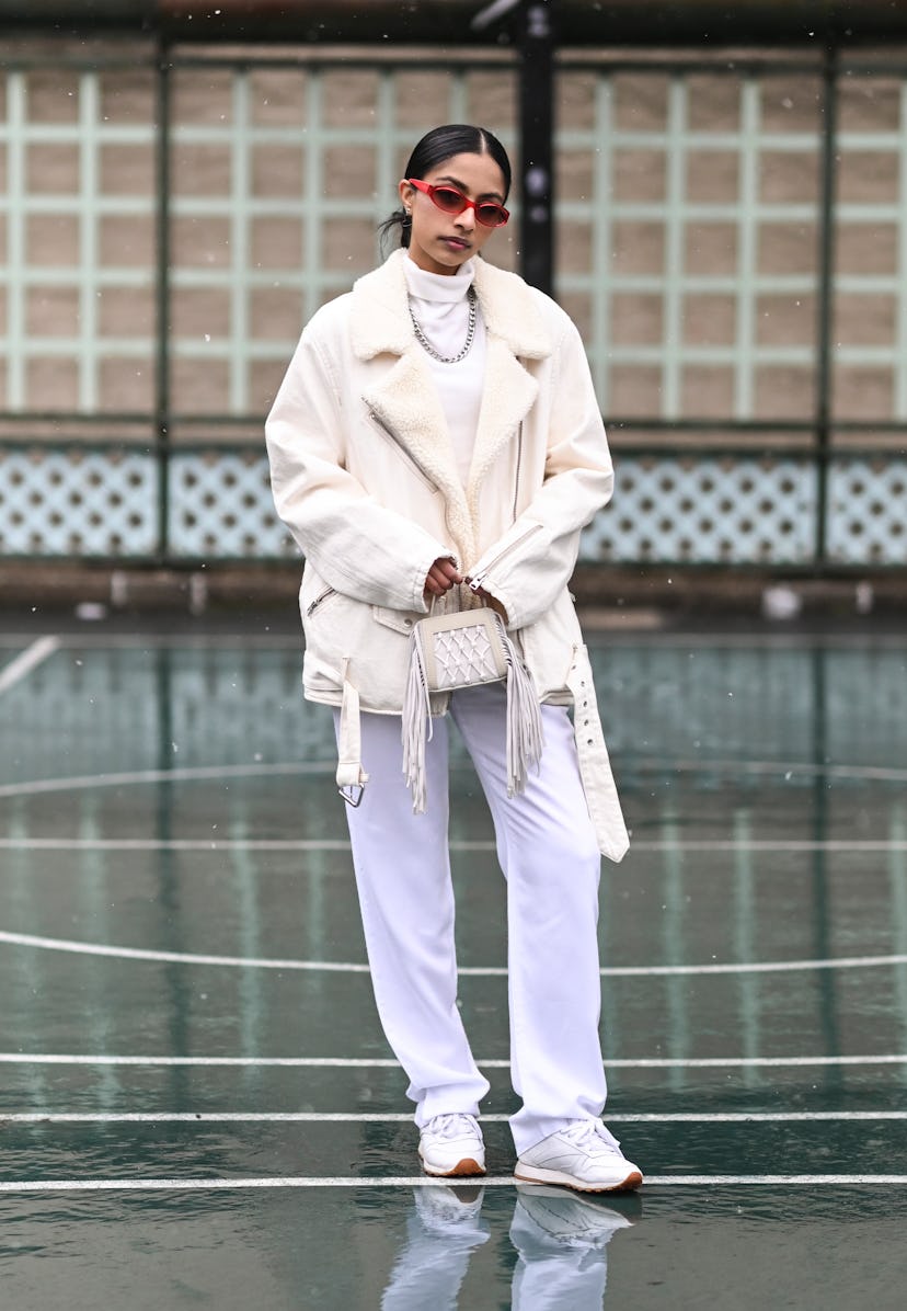 NEW YORK, NEW YORK - FEBRUARY 13: Malvika Sheth is seen wearing a white All Saints jacket, Tibi pant...