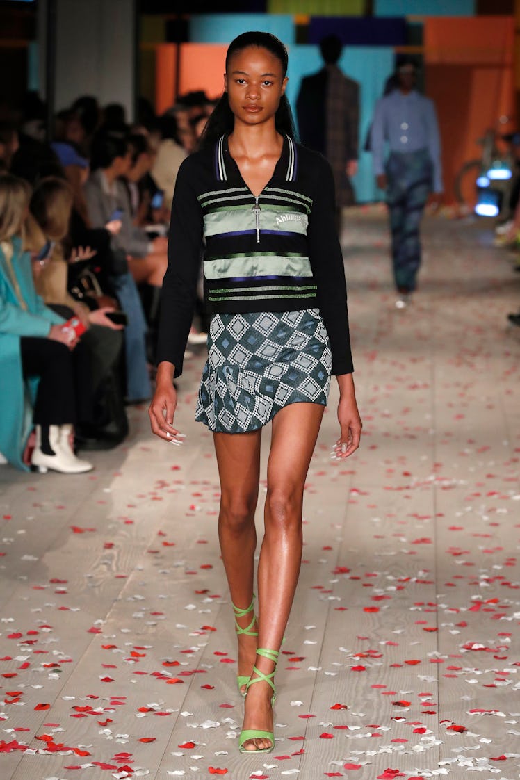 A model in a black-grey sweater and green-grey skirt by Ahluwalia at the London Fashion Week Fall 20...