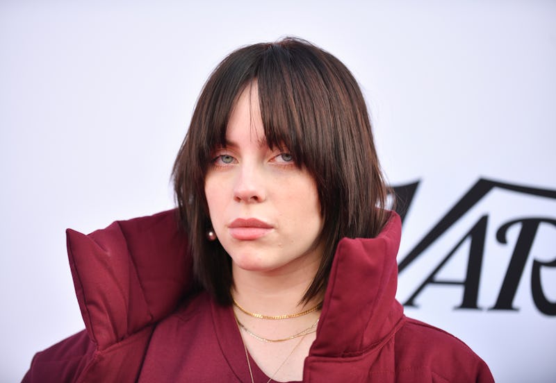 Billie Eilish has jet black hair that she styled in Y2K-approved space buns with shaggy bangs.