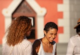 A young woman laughing with a friend on a sunny day. Aquarius season falls between Jan. 20 and Feb. ...