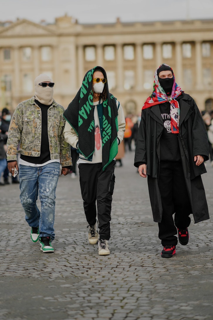 Man wearing a hooded top, sunglasses and Louis Vuitton Face Mask