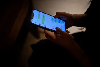 This picture taken on July 16, 2021 shows Melissa using her mobile phone to message her virtual boyf...