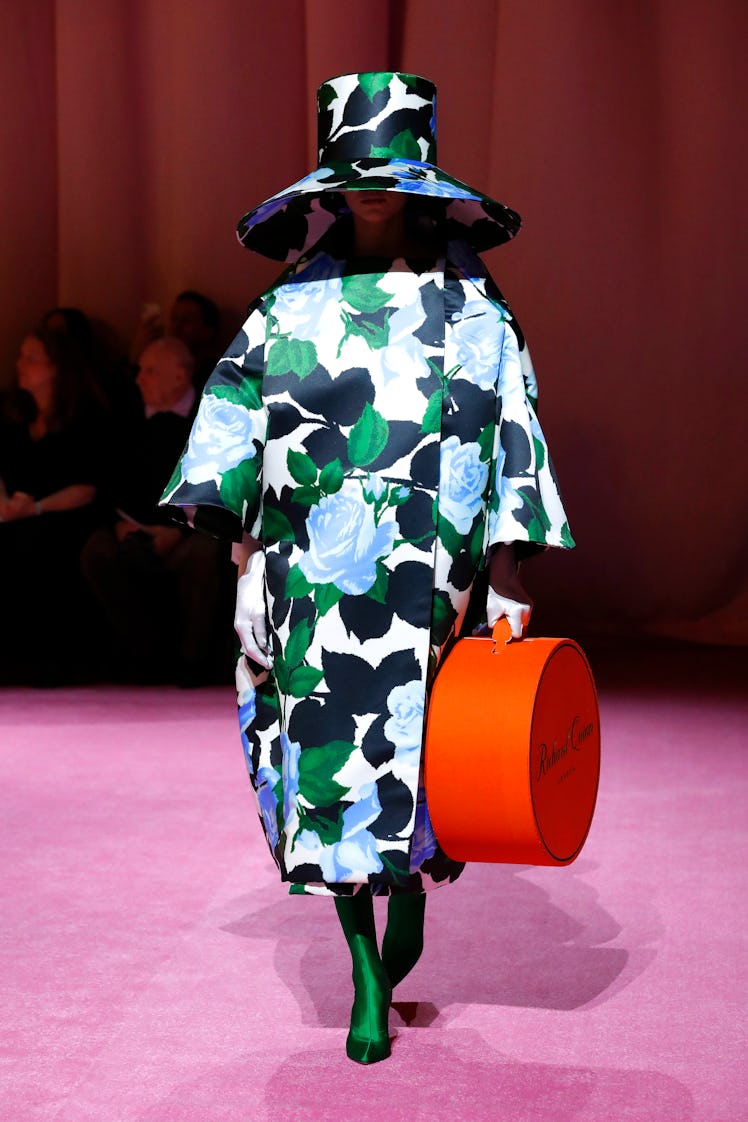 A model in a green-blue floral coat and hat by Richard Quinn at the London Fashion Week Fall 2022