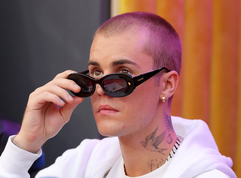 Singer Justin Bieber attends Super Bowl LVI before testing positive for COVID-19.