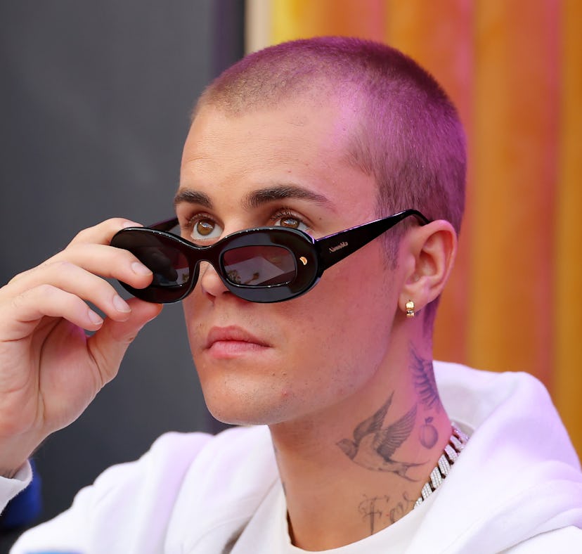 Singer Justin Bieber attends Super Bowl LVI before testing positive for COVID-19.