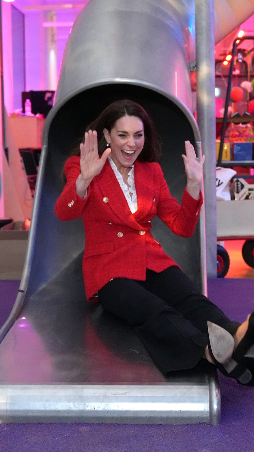 Catherine, Duchess of Cambridge uses a slide during a visit to the LEGO Foundation PlayLab on Februa...