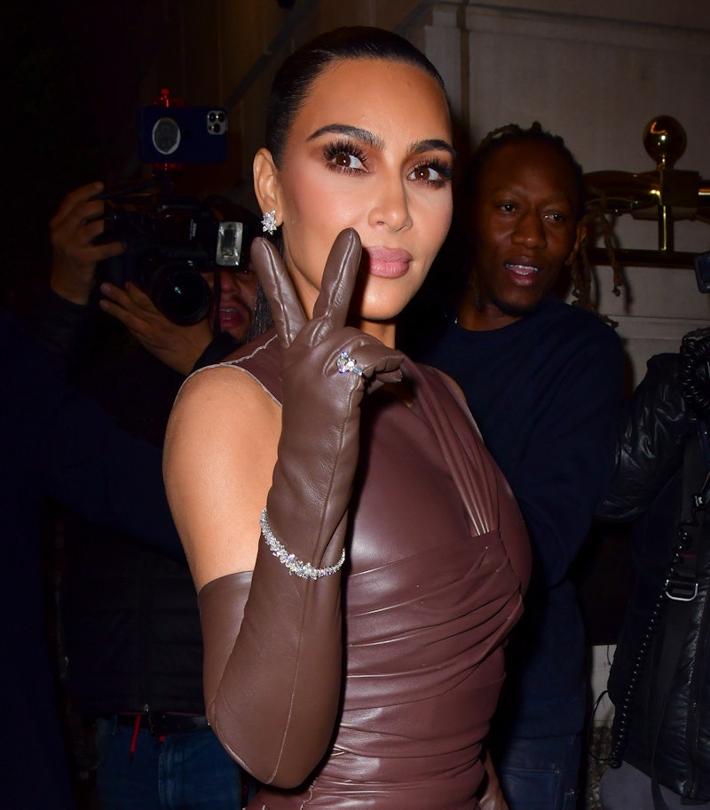 Kim Kardashian holding up a peace sign.