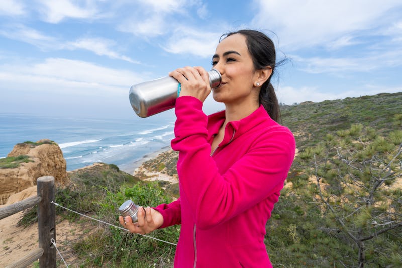 A woman hikes. Here's your daily horoscope for February 23, 2022.