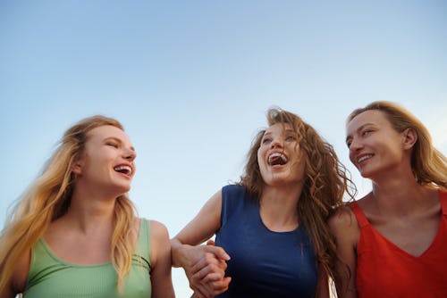 Three women having fun at the beach. A sun moon rising sign meaning explainer to help explain the bi...