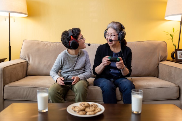 High quality stock photos of an 11-year-old boy playing video games and eating cookies with his gran...