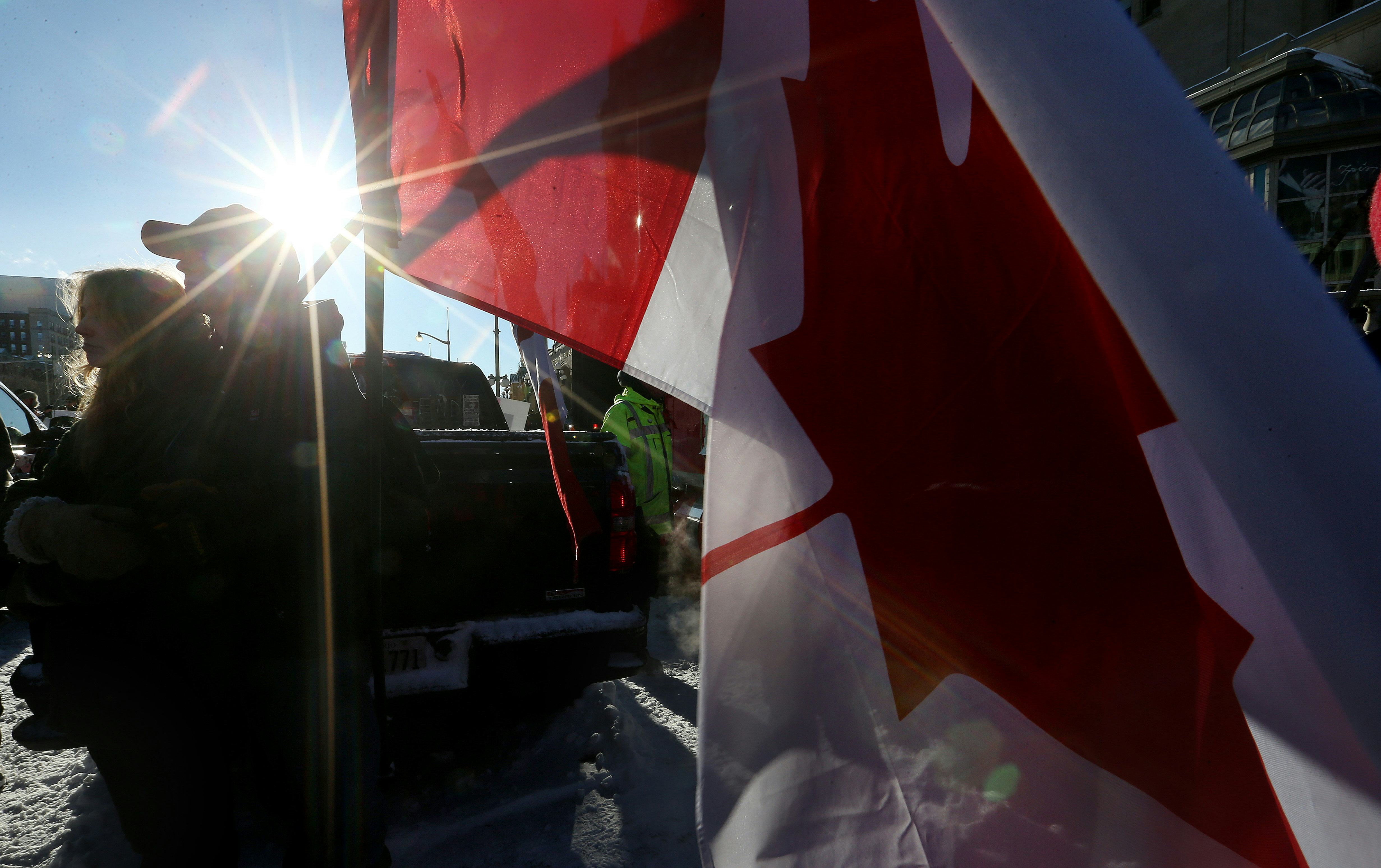 OTTAWA, ON- FEBRUARY 18  - A couple embrace as they watch  Police move a line of protesters from the...