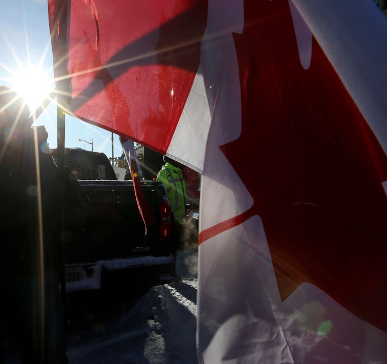 OTTAWA, ON- FEBRUARY 18  - A couple embrace as they watch  Police move a line of protesters from the...
