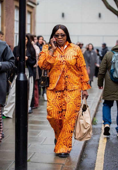 LONDON, ENGLAND - FEBRUARY 20: A guest is seen wearing top and pants in orange outside 16Arlington d...