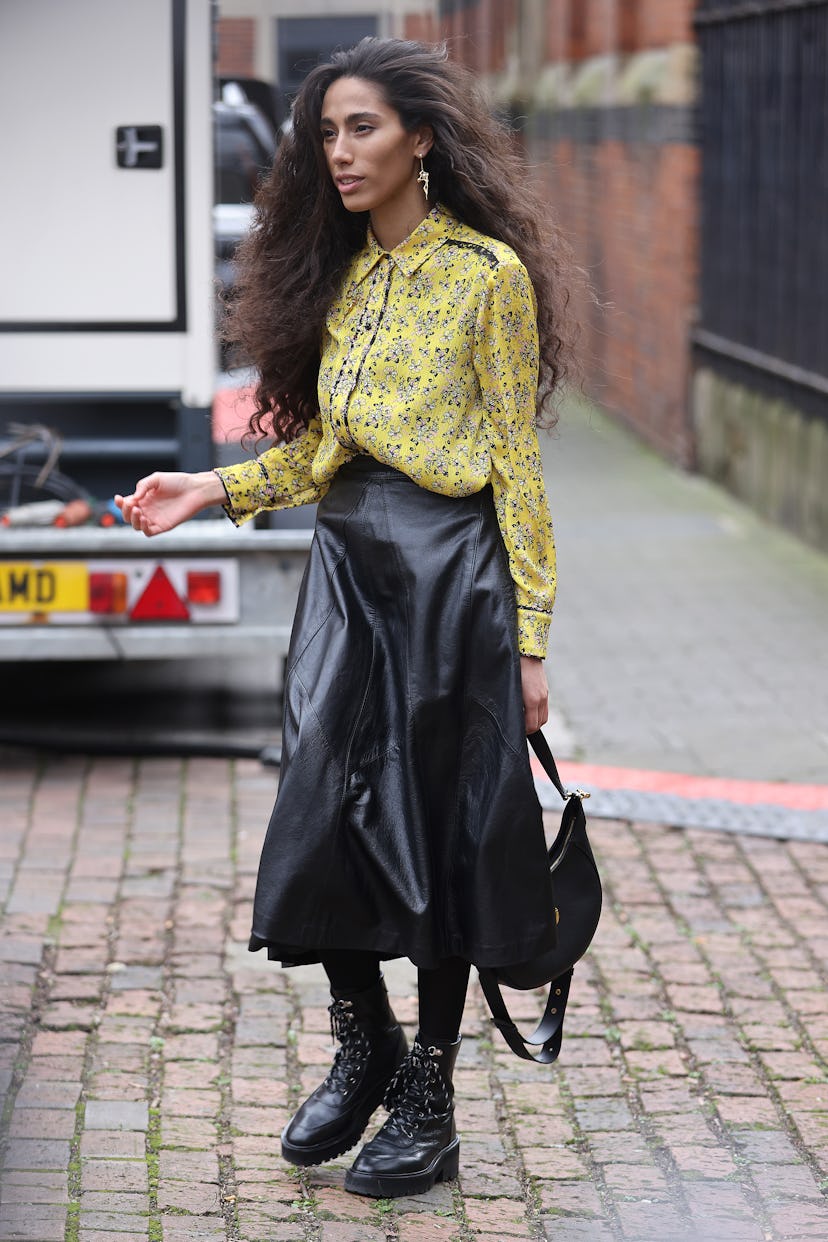 LONDON, ENGLAND - FEBRUARY 18: Guest in black leather skirt, yellow shirt attends Bora Aksu at St Ja...
