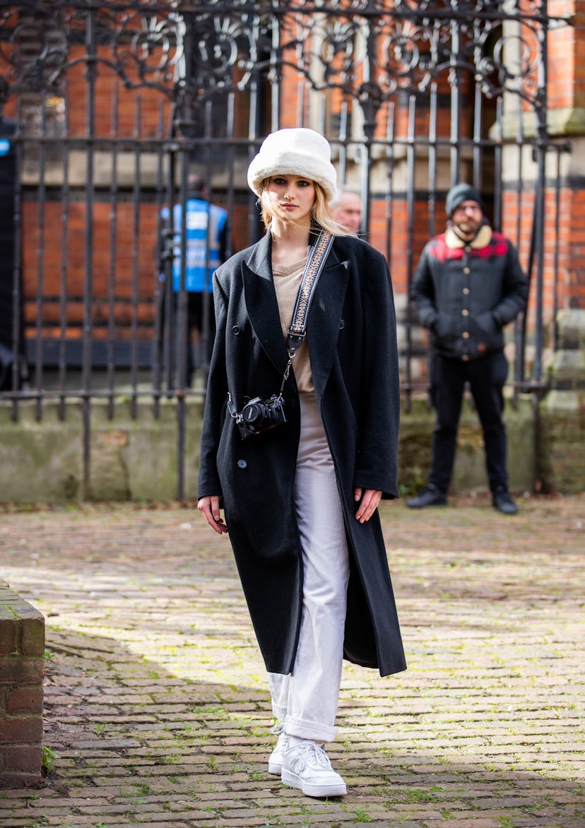 LONDON, ENGLAND - FEBRUARY 18: A model is seen wearing white bucket hat outside Bora Aksu during Lon...