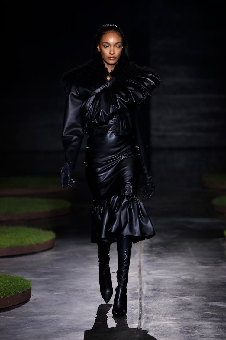 A model in a black leather frill dress by David Koma at the London Fashion Week Fall 2022