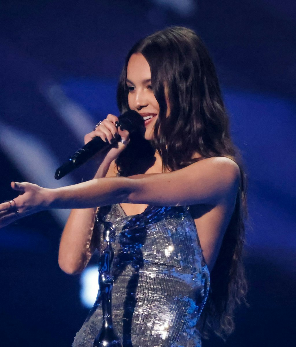 US singer and songwriter Olivia Rodrigo celebrates after receiving the international song of the yea...