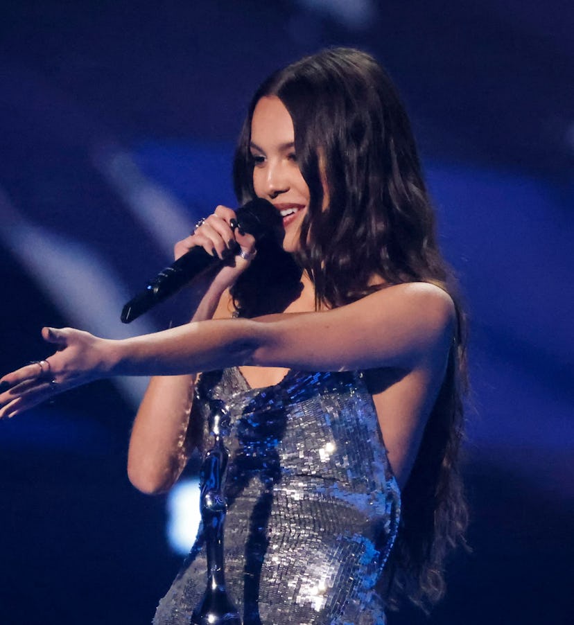 US singer and songwriter Olivia Rodrigo celebrates after receiving the international song of the yea...
