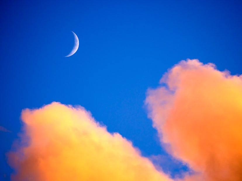 Clouds and new moon at sunset over Padstow, Cornwall, UK. The March 2022 new moon appears on Mar. 2.