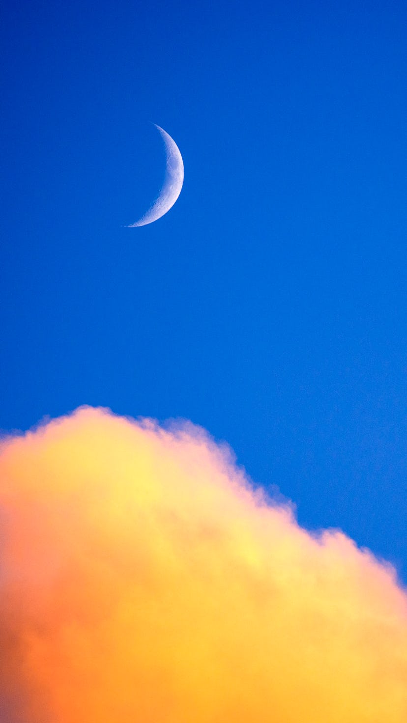 Clouds and new moon at sunset over Padstow, Cornwall, UK. The March 2022 new moon appears on Mar. 2.