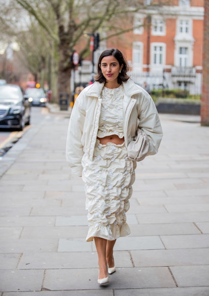 LONDON, ENGLAND - FEBRUARY 21: Bettina Looney seen wearing creme white cropped top, ruffled skirt, N...