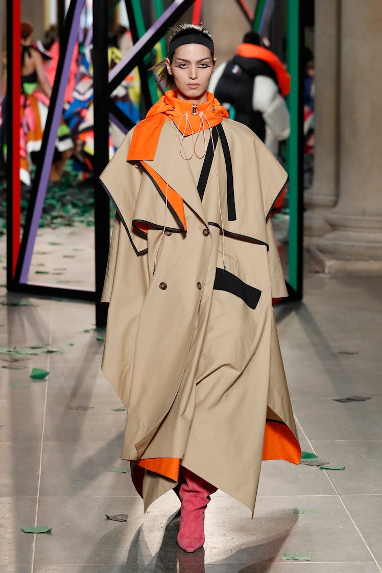 A model wearing a beige-orange coat by Roksanda  at the London Fashion Week Fall 2022