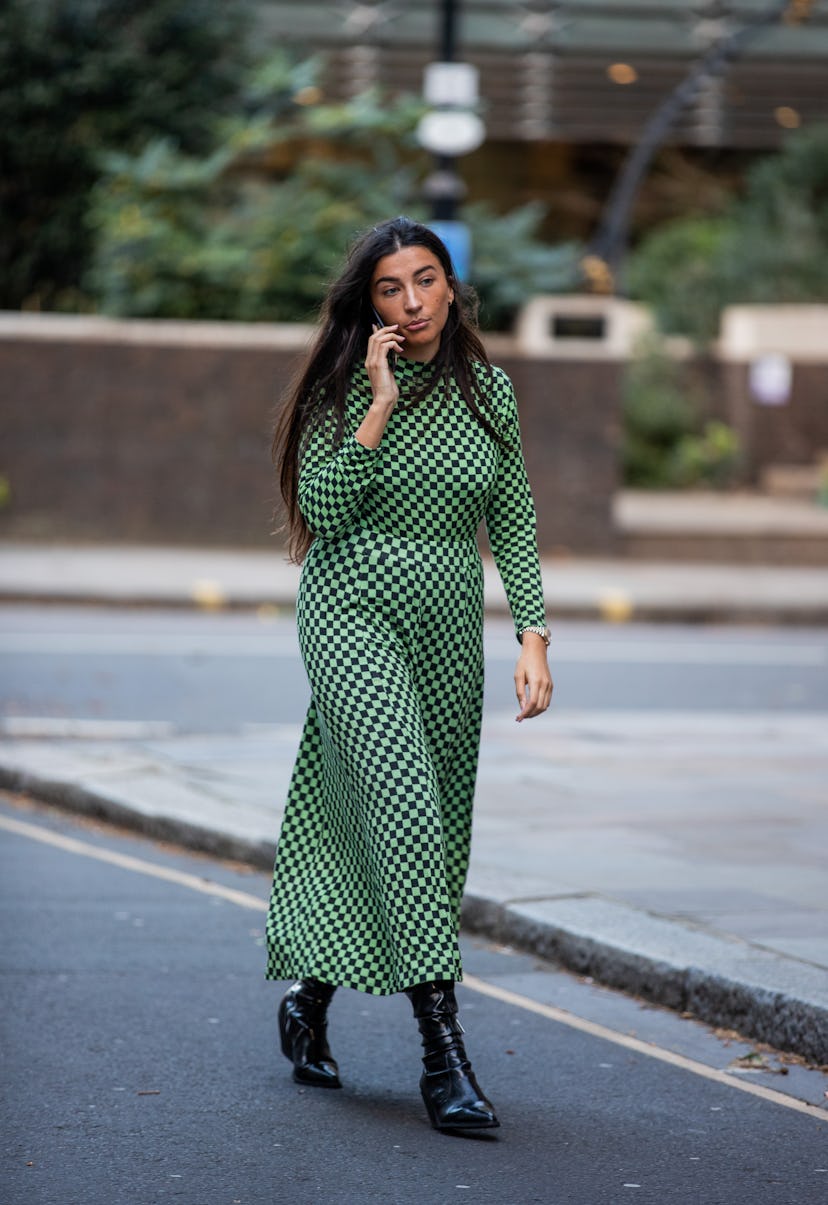 LONDON, ENGLAND - FEBRUARY 18: A guest is seen wearing green black checkered dress outside Rixo duri...