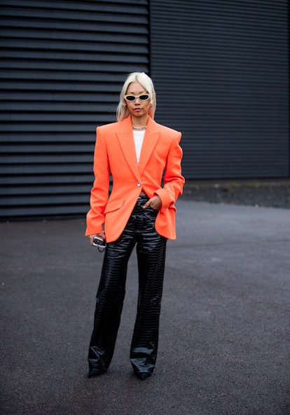 LONDON, ENGLAND - FEBRUARY 20: Vanessa Hong seen wearing orange blazer, black vinyl pants outside Da...