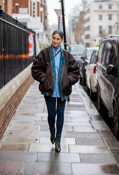 LONDON, ENGLAND - FEBRUARY 19: Caroline Issa seen wearing brown Prada bomber jacket, blue button shi...