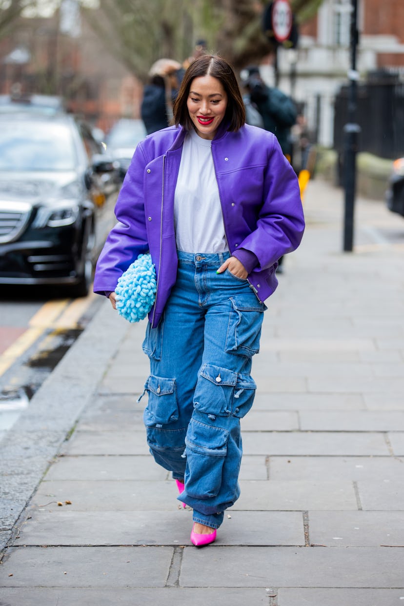 LONDON, ENGLAND - FEBRUARY 21: Tiffany Hsu seen wearing purple jacket, denim jeans with pockets, blu...