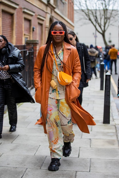 LONDON, ENGLAND - FEBRUARY 20: A guest is seen wearing Fendi bag, suede brown coat, button shirt & p...