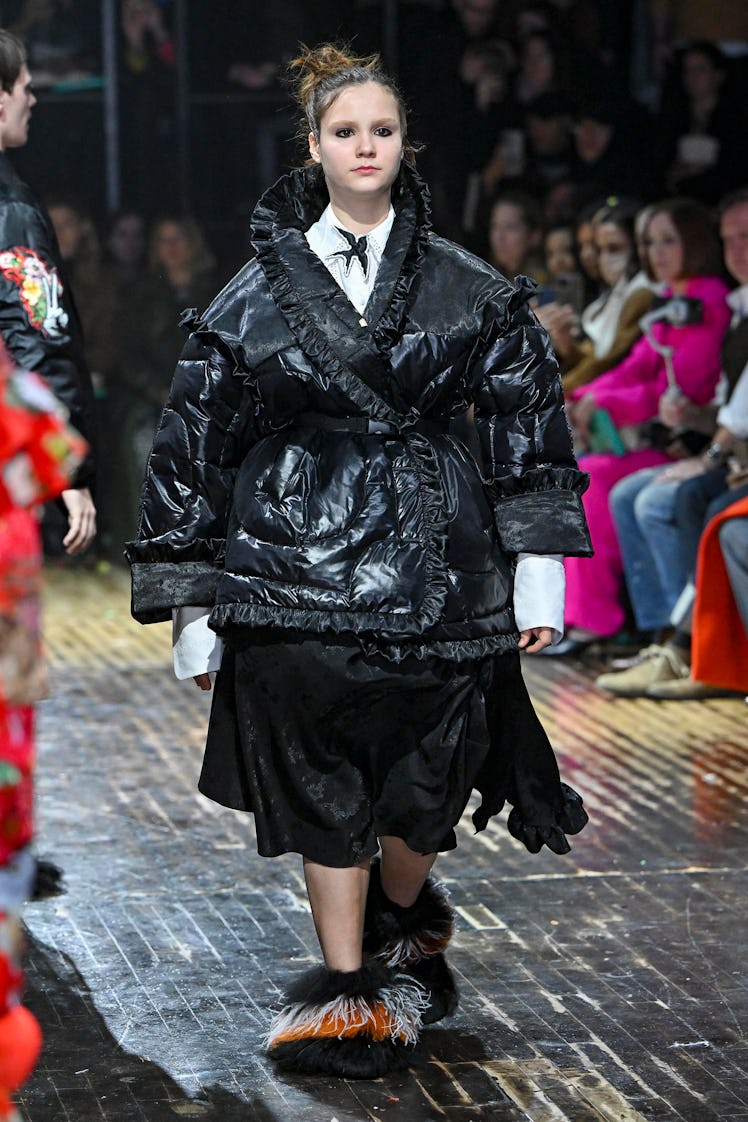 A model wearing a black puffer Preen by Thornton Bregazzi and skirt at the London Fashion Week Fall ...