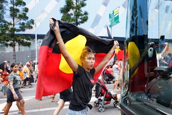 BRISBANE, QUEENSLAND, AUSTRALIA - 2020/01/26: Protester with a flag marching through the streets of ...