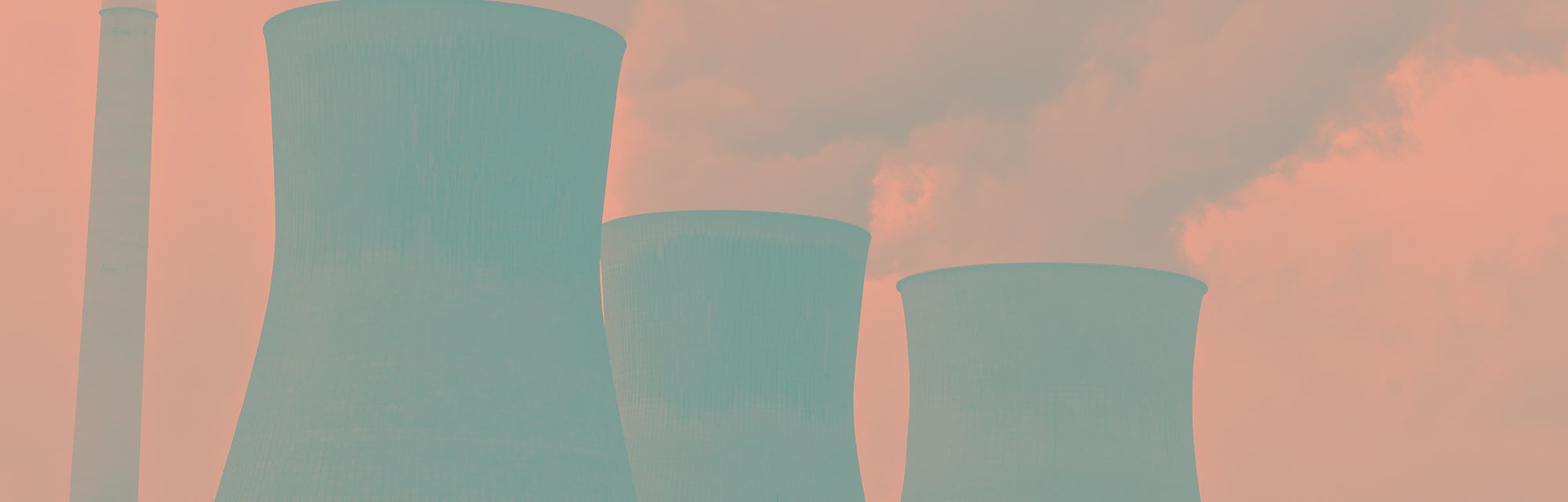 2007 - Smoke fills the air from cooling towers of a power plant along a river. (Photo by: HUM Images...