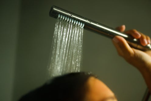 Close up of unrecognizable woman washing hair in bathroom.