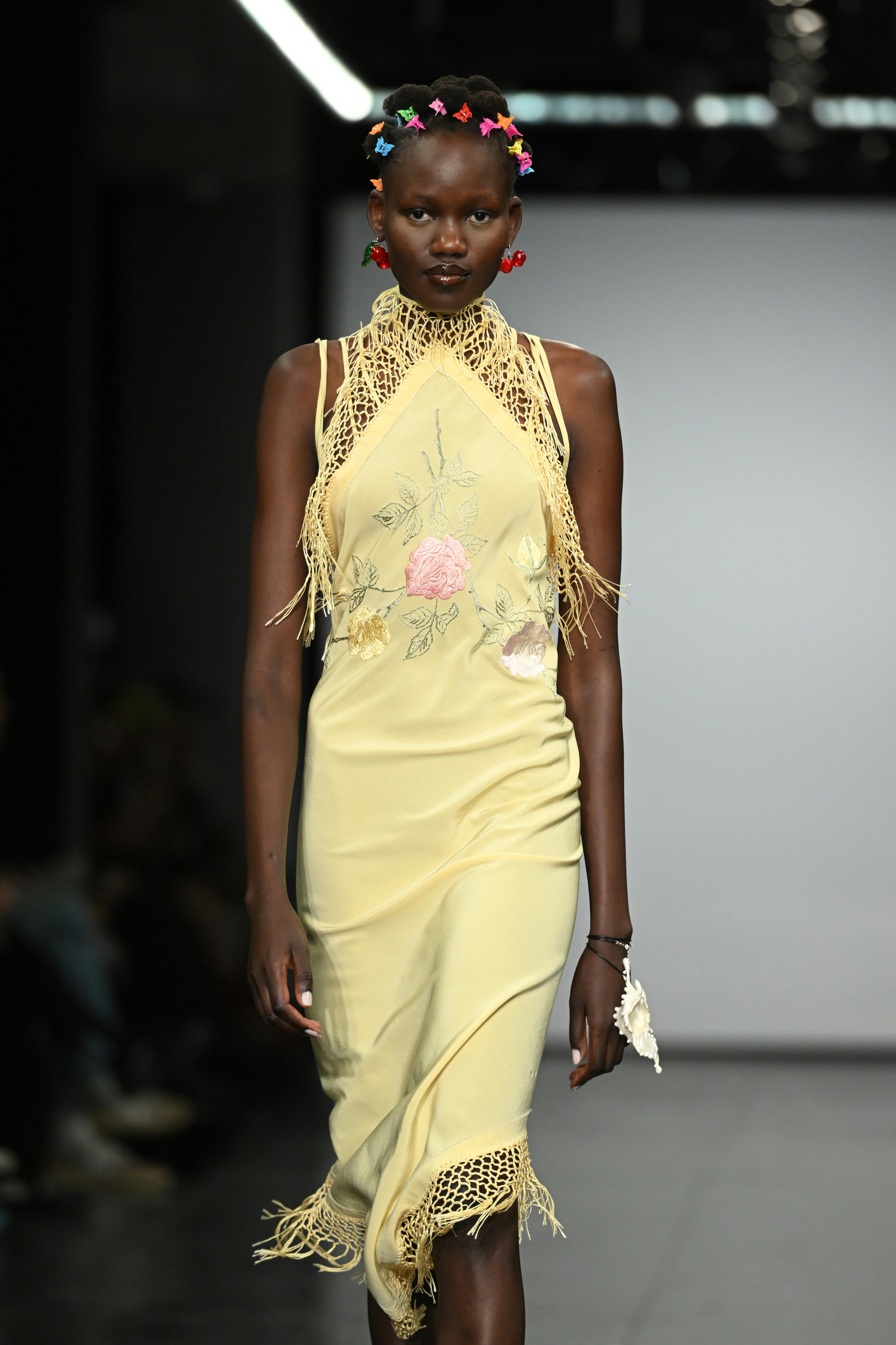 At London Fashion Week F/W 2022, a model walks the runway at the Conner Ives show with butterfly cli...