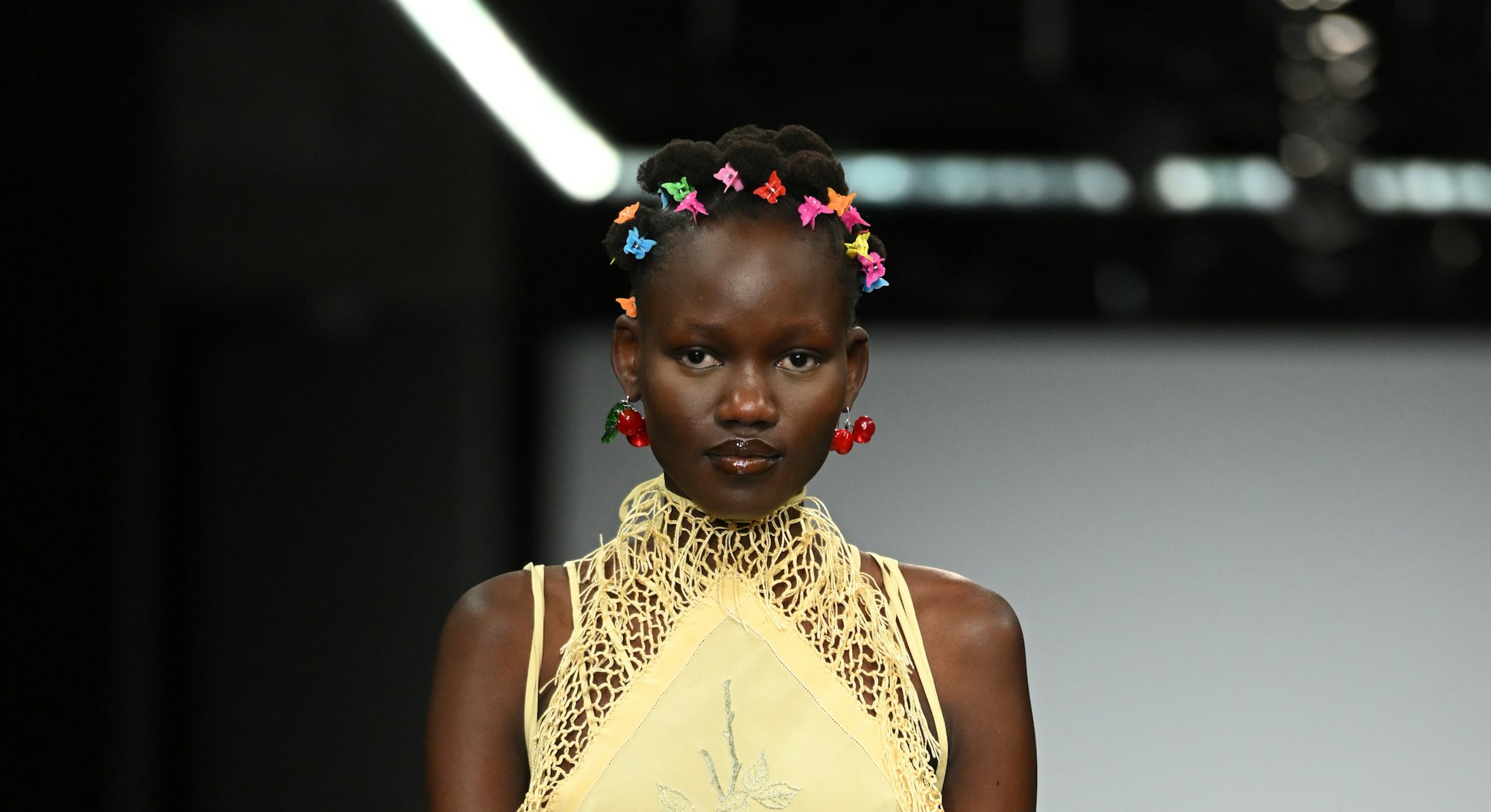 At London Fashion Week F/W 2022, a model walks the runway at the Conner Ives show with butterfly cli...