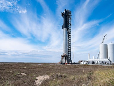 SpaceX's first orbital Starship SN20 is stacked atop its massive Super Heavy Booster 4 at the compan...