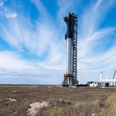 SpaceX's first orbital Starship SN20 is stacked atop its massive Super Heavy Booster 4 at the compan...