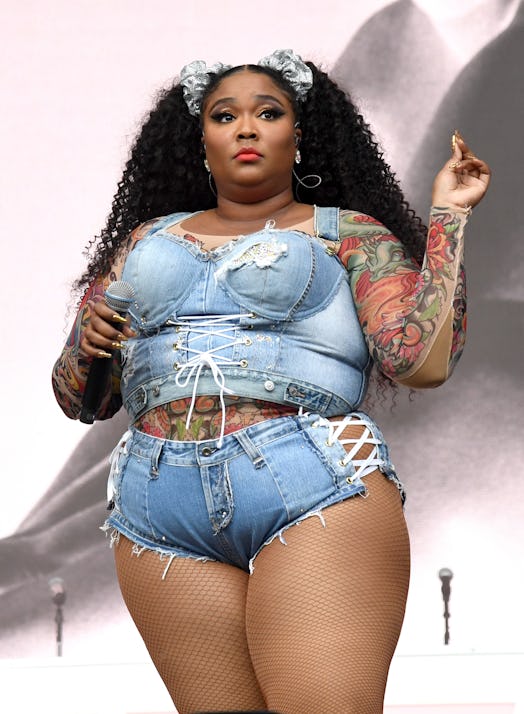 Lizzo wearing a denim corset onstage during Made In America