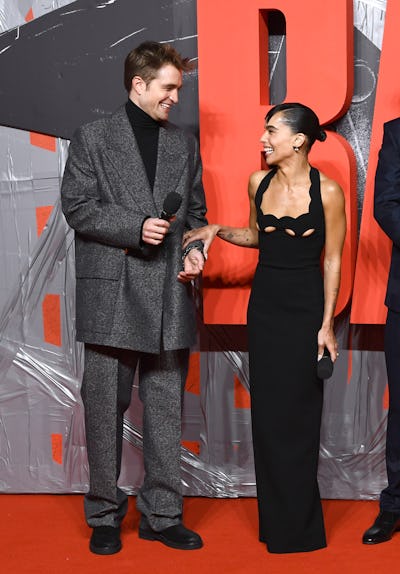 Robert Pattinson and Zoe Kravitz in an oversized suit and black gown (respectfully) at "The Batman" ...